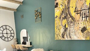 A modern living room with a teal accent wall, a large abstract painting, and a mix of contemporary and classic furniture. - LE MAS Calisto (TRANS EN PROVENCE)