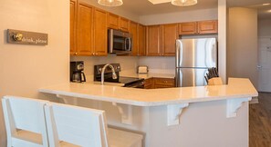 Enjoy cooking in this well-equipped kitchen with a central island, sink, and stovetop.