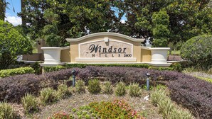 A landscaped sign for Windsor Hills 2600 with a variety of plants and shrubs.