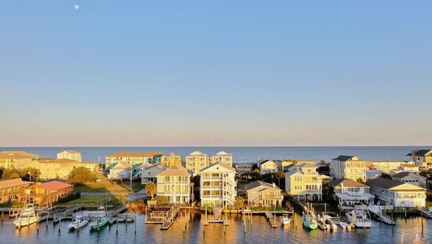 A coastal residential area with houses and boats docked at a marina. - Stunning Harbor Views! Boat Slip, 2 King Bedrooms, (Carolina Beach)