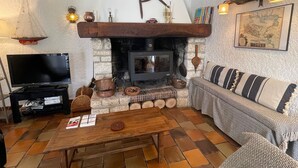 A cozy living room with a fireplace, a television, and a sofa. - Pretty house in a large garden / town center,  (La Flotte)