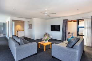 Deluxe Apartment | Living area | 32-inch LCD TV with satellite channels, TV, DVD player