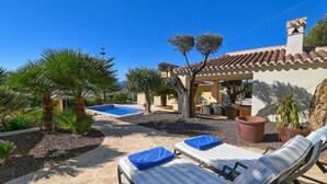 A pool area with lounge chairs and a pergola. - El Elefante 4 pax - Javea, Costa Blanca (Javea)