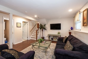 Relax in a comfortable seating area with a sofa, coffee table, and fireplace.