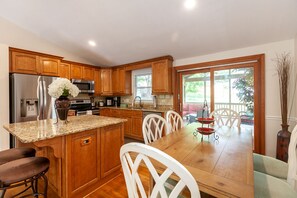 Enjoy meals in the kitchen, which offers a dining area and access to a patio with outdoor views.