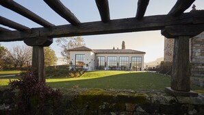 A large building with multiple windows and a well-maintained lawn in front.