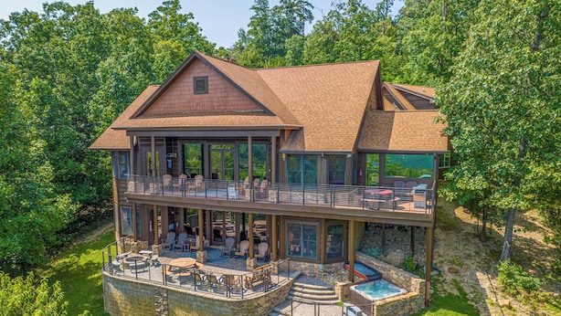 A two-story house with a large deck, outdoor seating, and a swimming pool. - Five Bears Mountain View Lodge - Private Mtn Views -  Ultimate Luxury Cabin (Sevierville)