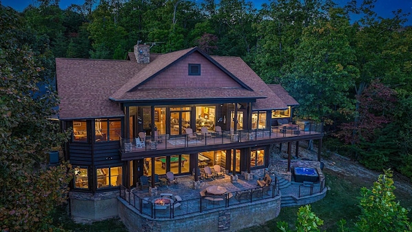Experience the perfect blend of indoor and outdoor living in this spacious, two-story house with a large balcony and open-plan interior featuring a dining and seating area.