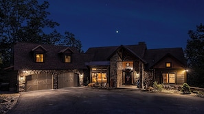 Traditional two-story house with a prominent front entrance and stone archway.