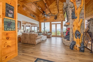 Relax in a spacious lodge with a high ceiling and large windows offering a view of the surrounding landscape.