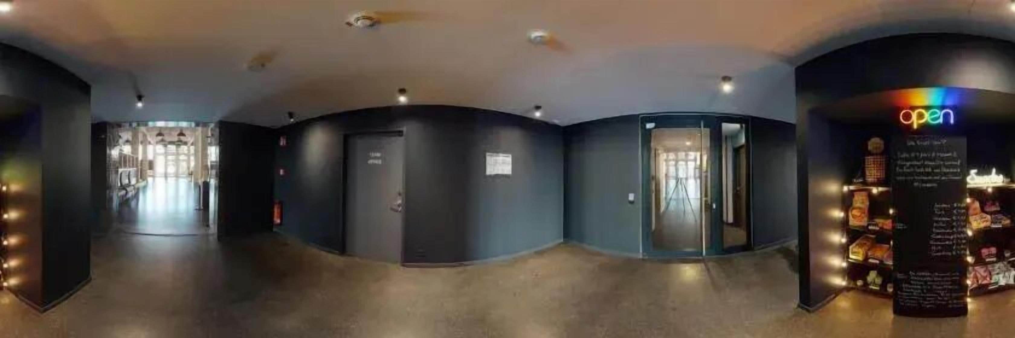 A corridor with doors leading to rooms, a reception area, and a store with a sign that says 'open'.