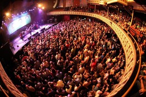 A large, circular auditorium filled with people, likely attending an event or concert. - Condo in the Heart Atlanta w/ Private Balcony (Atlanta)