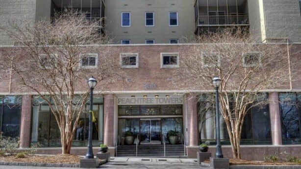 A building with a sign reading "Peachtree Towers." - Condo in the Heart Atlanta w/ Private Balcony (Atlanta)