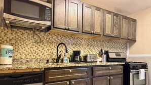 A kitchen with a microwave, toaster, coffee maker, and dishwasher. - Upgraded 2BR Condo Near ATL Attractions (Atlanta)