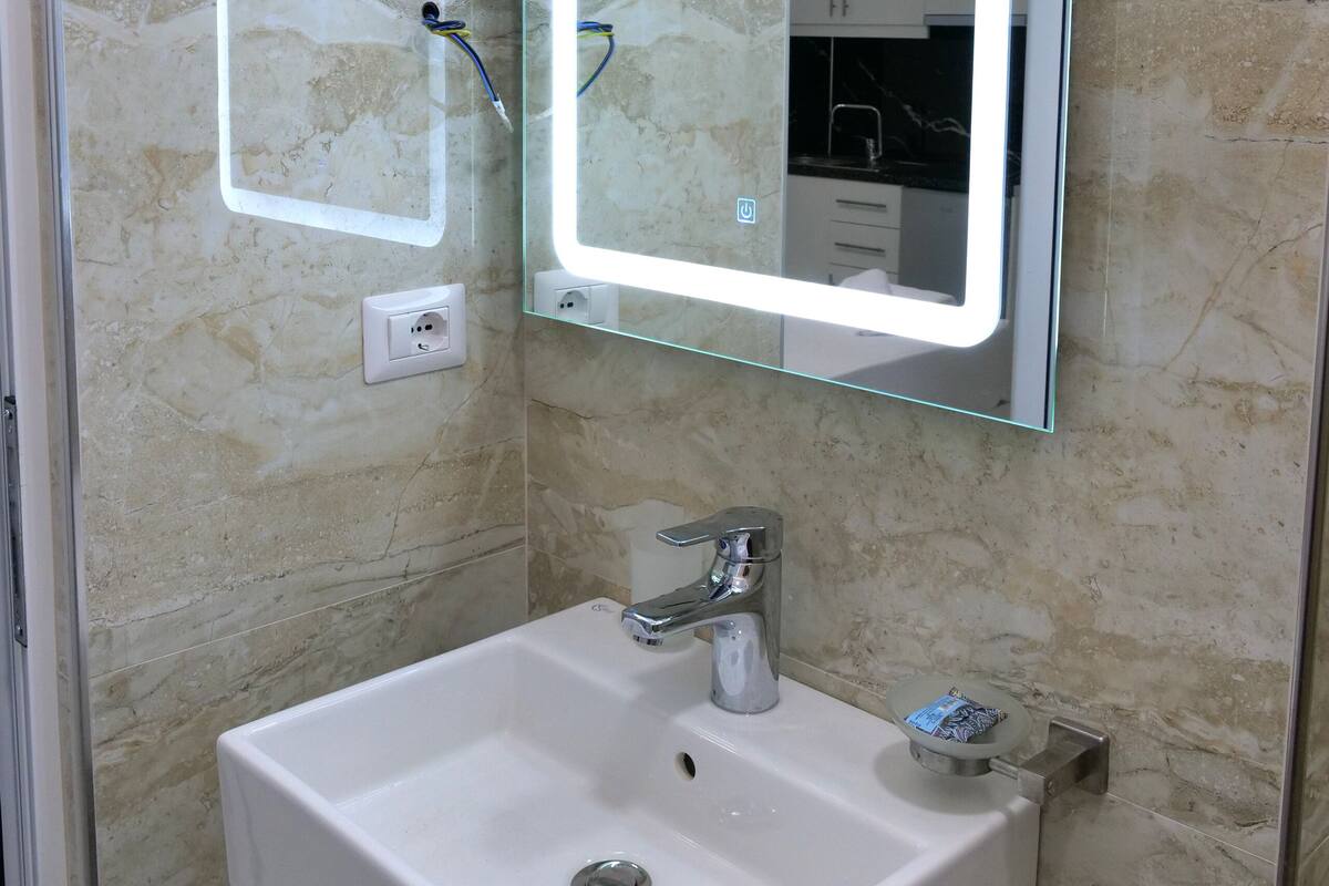 Shower, rainfall showerhead, hair dryer, towels
