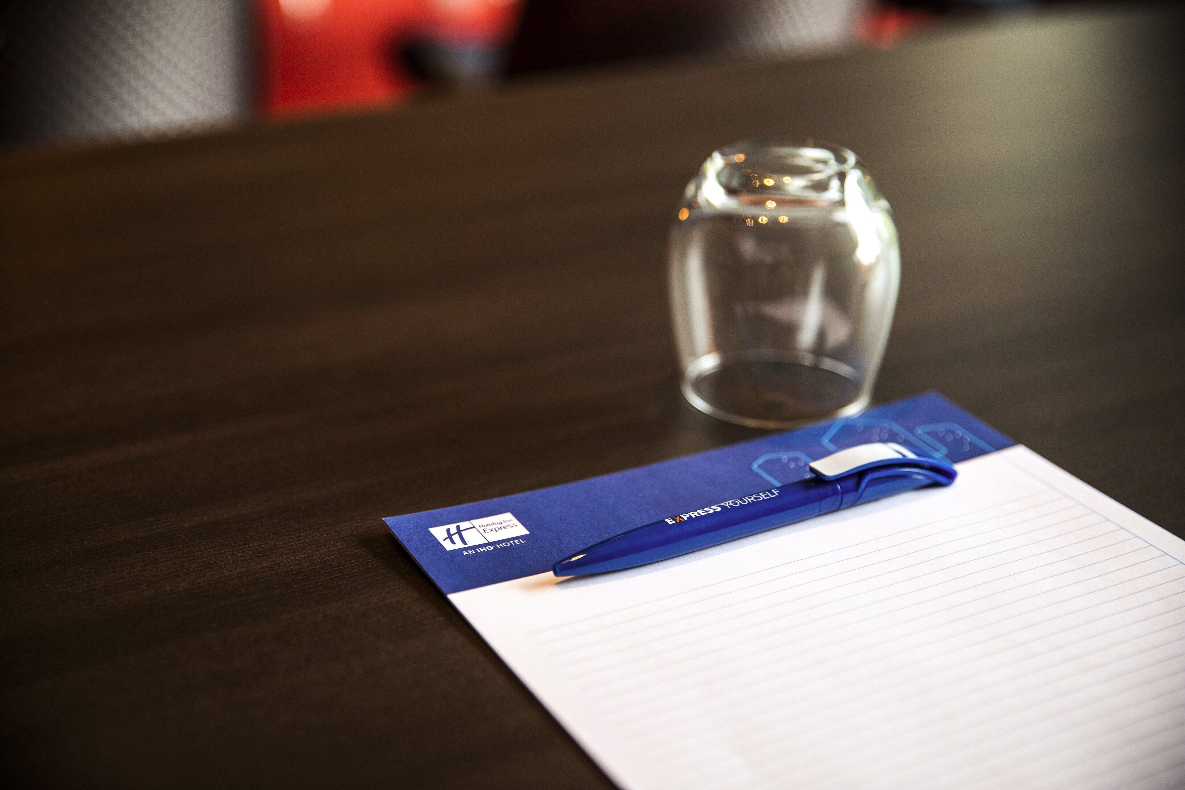 A notepad with a pen on a table.