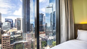 A hotel room with a large window offering a cityscape view. - Holiday Inn Express Melbourne Little Collins by IHG (Melbourne)