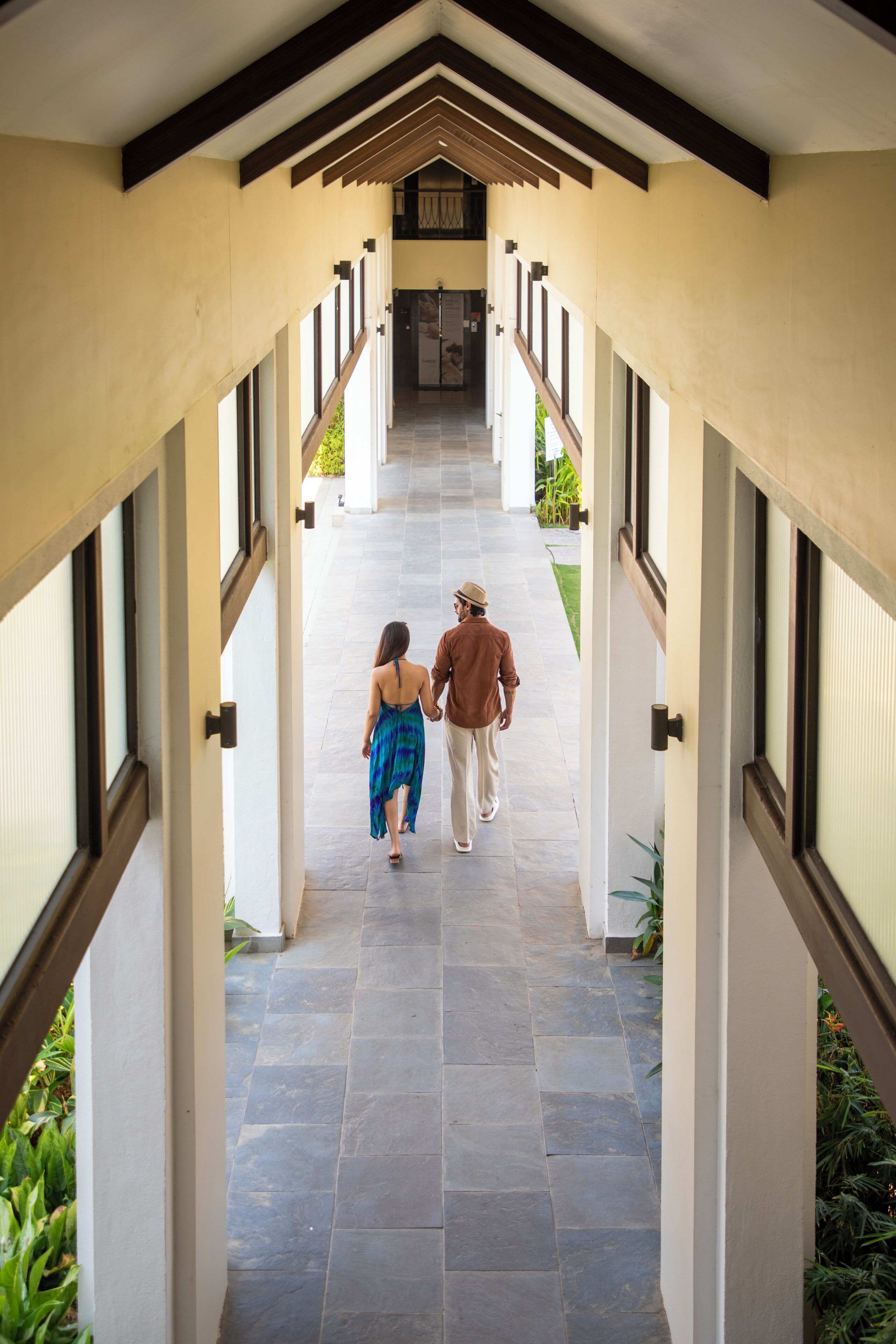 A covered walkway with a tiled floor and wooden beams.