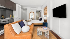 Een moderne woonkamer met een bank, salontafel en een flatscreen-tv.
