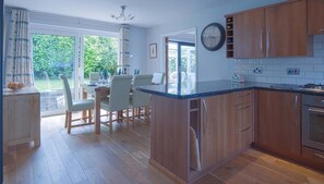 Enjoy cooking in this well-lit kitchen with a central island and stainless steel appliances.