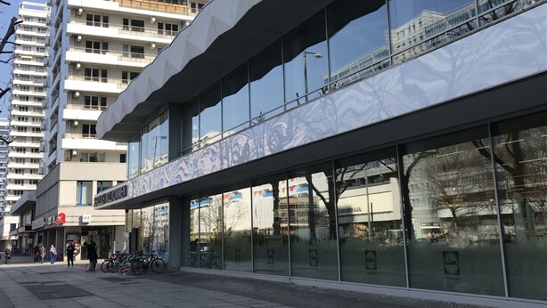 A modern building with large glass windows and a flat roof. - Space Night - Hostel (Berlin)