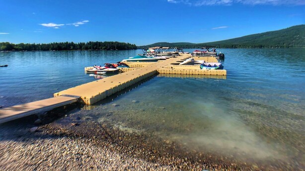A pier extending into a lake with boats docked at the end. - Lakefront Property- Newly Updated Four Bedroom House, Sleeps 10 (Whitefish)