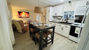 Enjoy cooking and dining in this fully equipped kitchen with an oven, sink, and dining table for four.