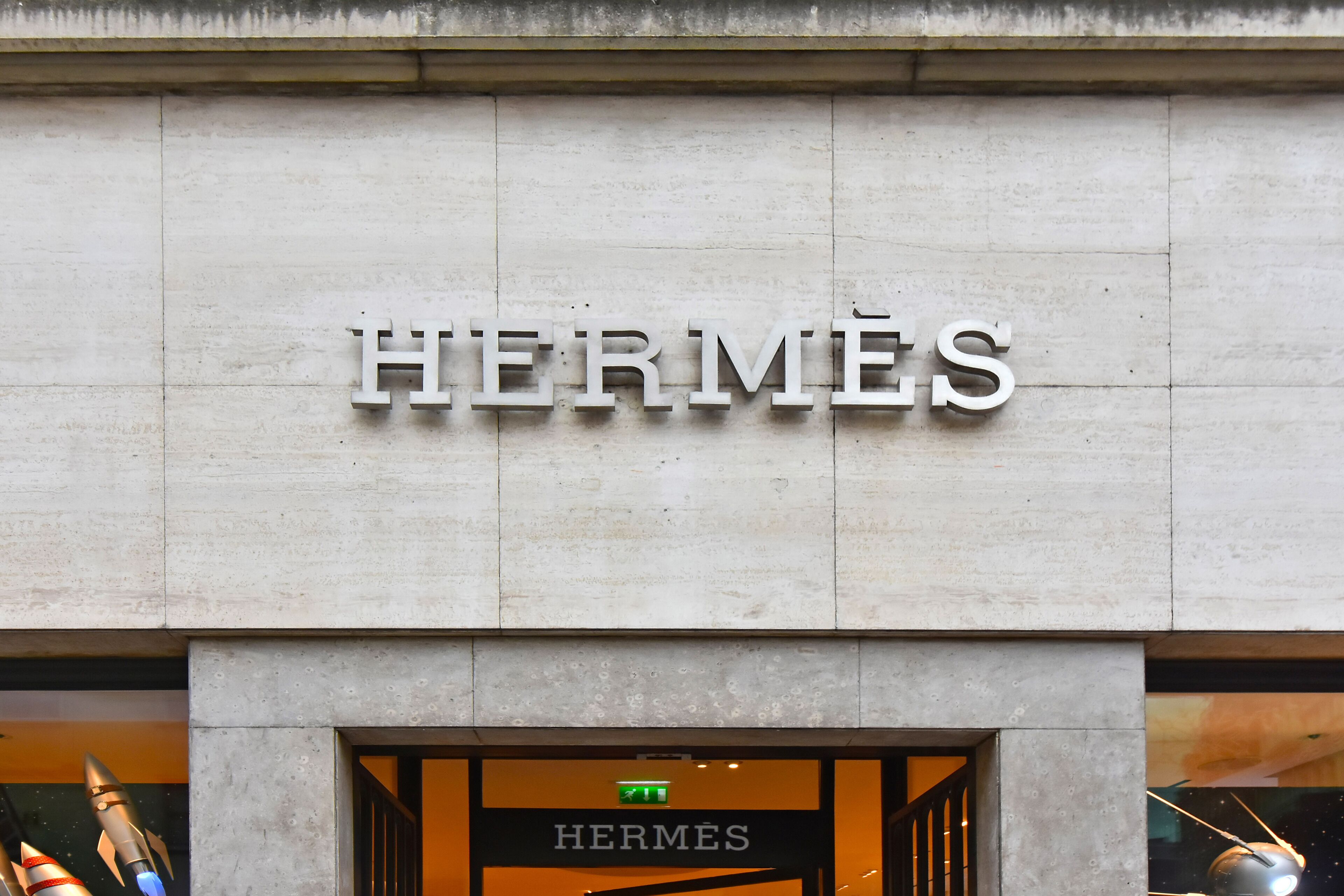 A storefront with the word "HERMÈS" prominently displayed on the facade.