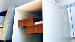 A modern, minimalist room with a white console table, a clock on the wall, and a lamp. - WENDY APARTMENT HOME AWAY FROM HOME (Aberdeen)