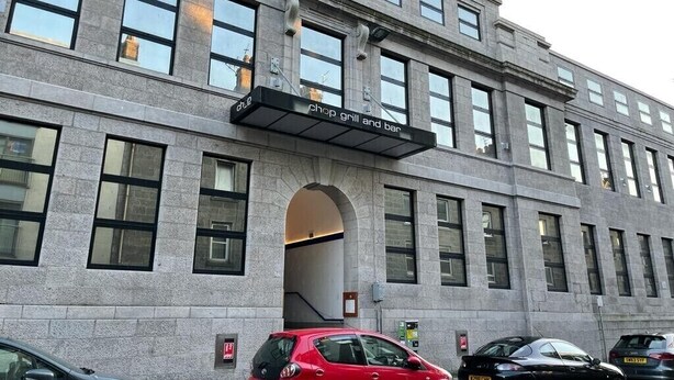 A building with a 'Chop Grill and Bar' sign, large windows, and a stone facade. - WENDY APARTMENT HOME AWAY FROM HOME (Aberdeen)