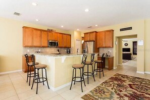 Enjoy cooking in this well-equipped kitchen with a central island and bar stools.