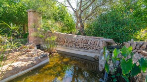 A stone structure with a water feature, surrounded by lush greenery. - LO D'EN CREUS - Fantastic country house with an above-ground pool, perfect for couples. Fr (Campos)