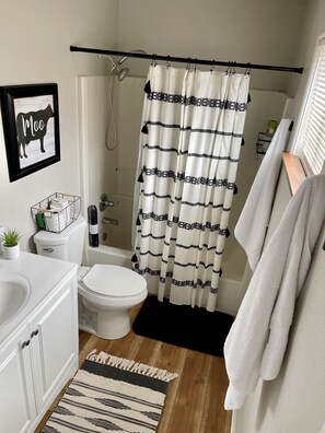 Combined shower/bathtub, towels, soap, toilet paper