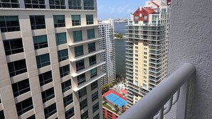 A high-rise building with multiple floors, large windows, and a view of a body of water. - Mesmerizing Studio Brickell +Free Parking + Gym+Pool (Miami)