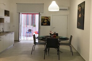 Enjoy meals in this stylish dining area with a round table for four, pendant light, and framed artwork.