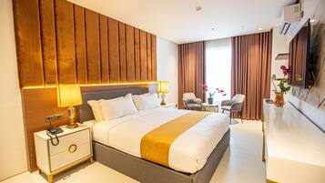 A modern hotel room with a large bed, bedside lamps, a desk, and a view of the city.