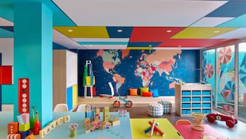 Explore the world with a fun-filled playroom featuring a colorful map, building blocks, and educational materials.