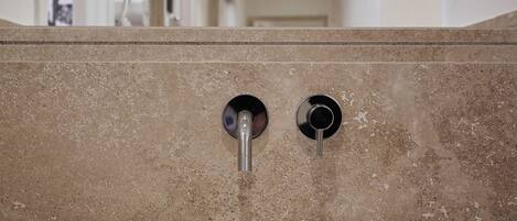 A bathroom with a white sink, a mirror, and a towel.