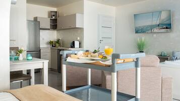 Presidential Studio Suite | Living area | 80-cm plasma TV with cable channels, TV