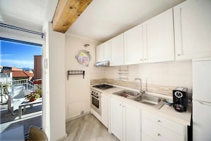 Fridge, oven, coffee/tea maker, cookware/dishes/utensils