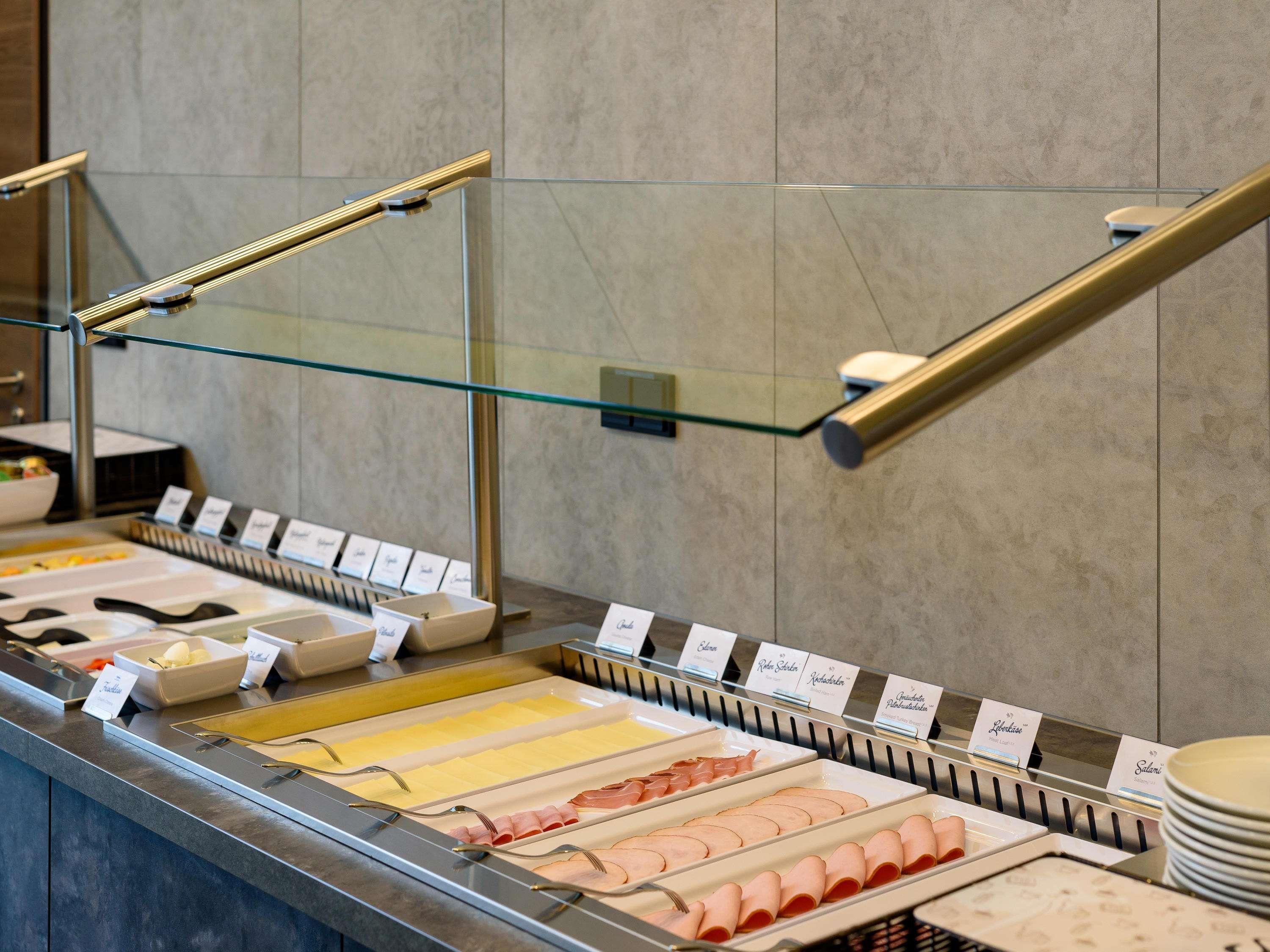 A buffet area with various food items and labels.
