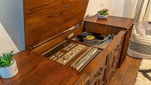 A wooden cabinet with a built-in record player and turntable.
