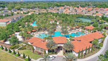 Enjoy a serene atmosphere surrounded by lush greenery and a sparkling pool in this secure community.