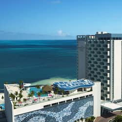 Enjoy stunning ocean views from the rooftop pool area, surrounded by sun loungers and umbrellas.