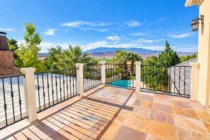 A balcony with a pool, surrounded by a fence, and a view of mountains. - Private Pool & Outdoor Kitchen (Hurricane)