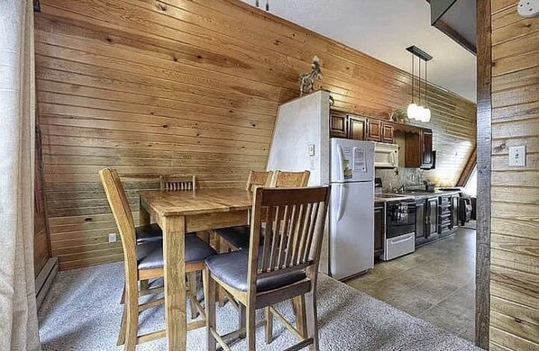 Enjoy meals in this kitchen area with an oven and dining table for two.