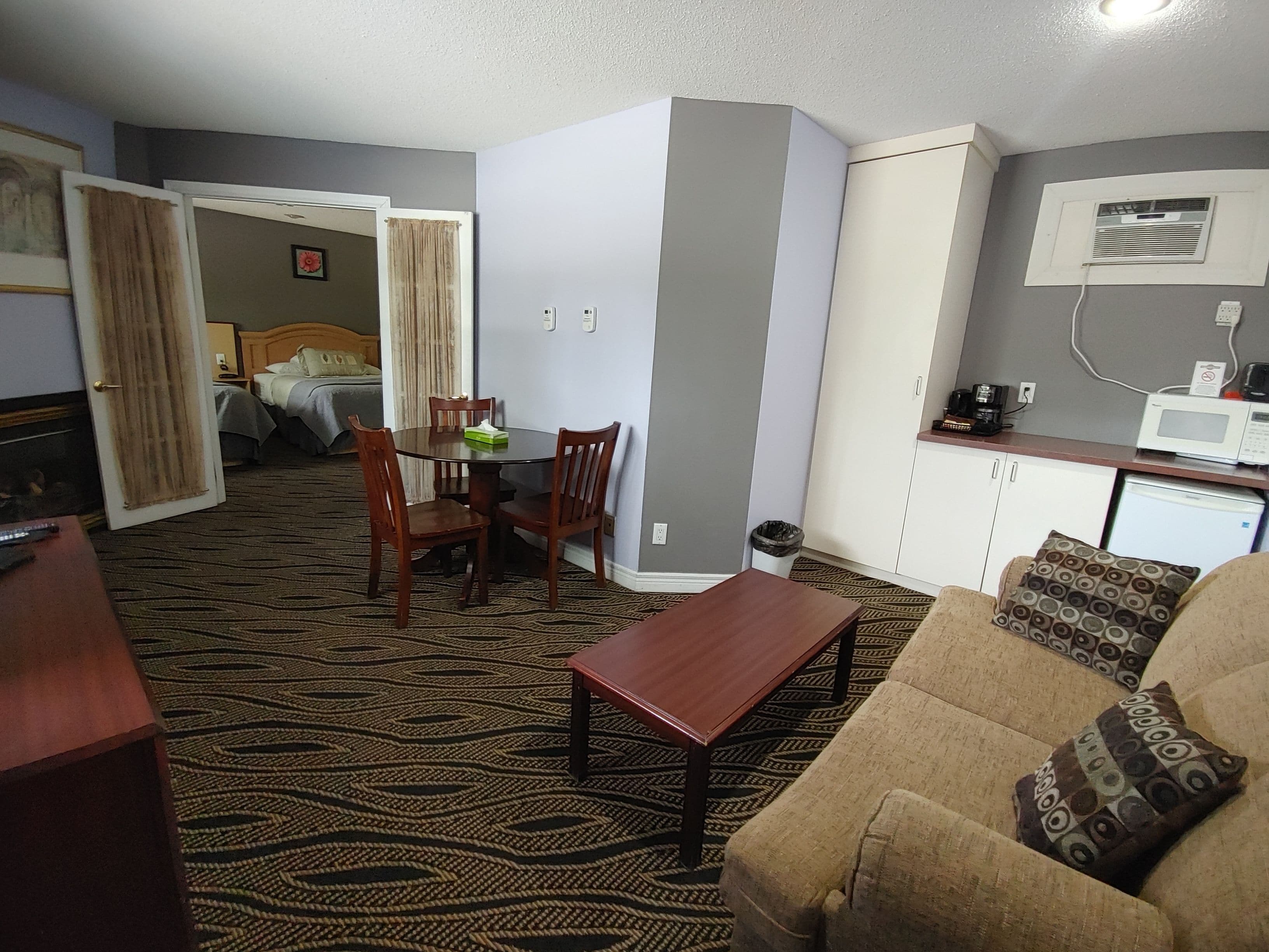 Deluxe Suite with Two Queen Beds | Living area | 32-inch LCD TV with cable channels