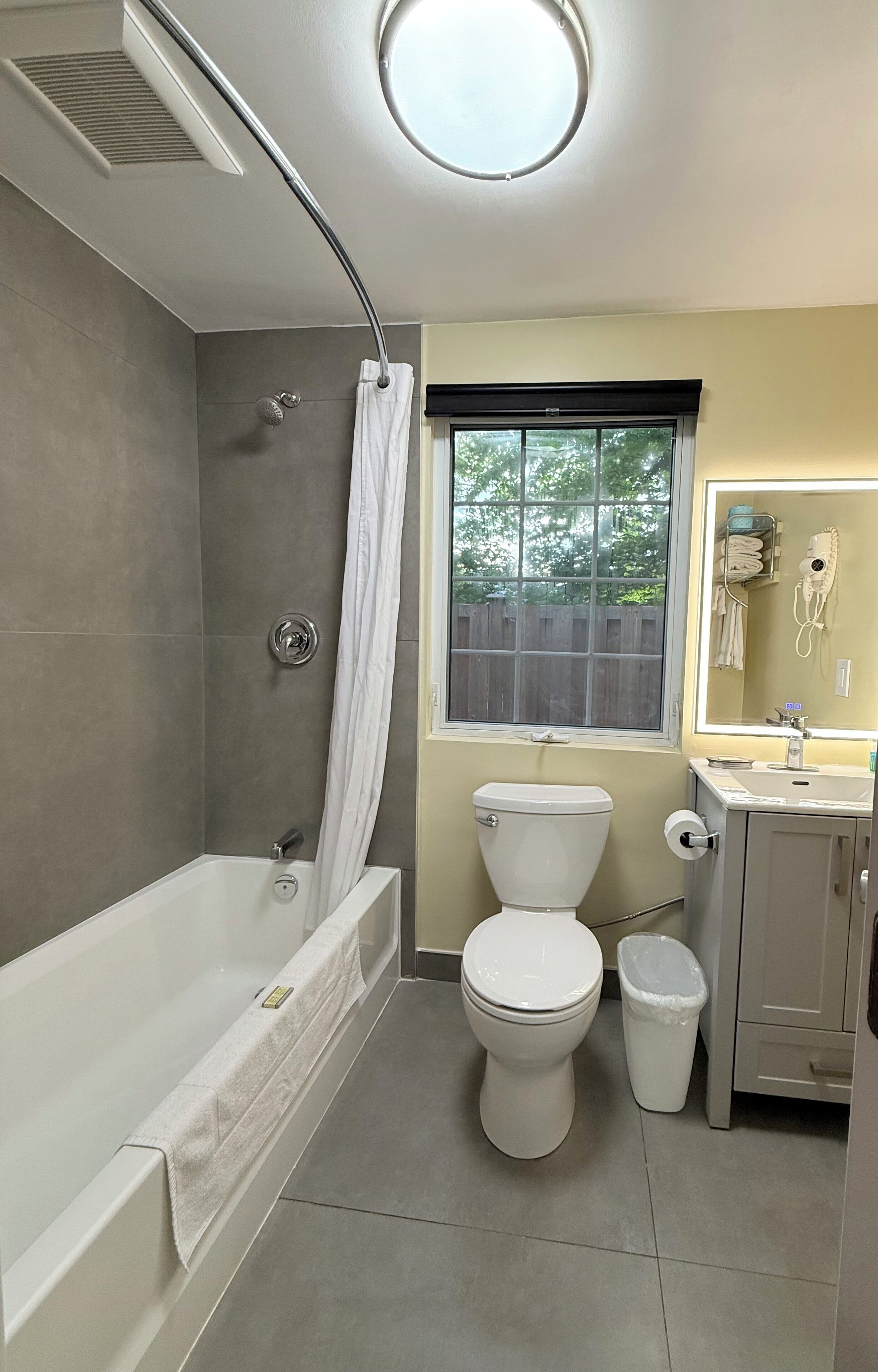 A bathroom with a bathtub, toilet, and sink.