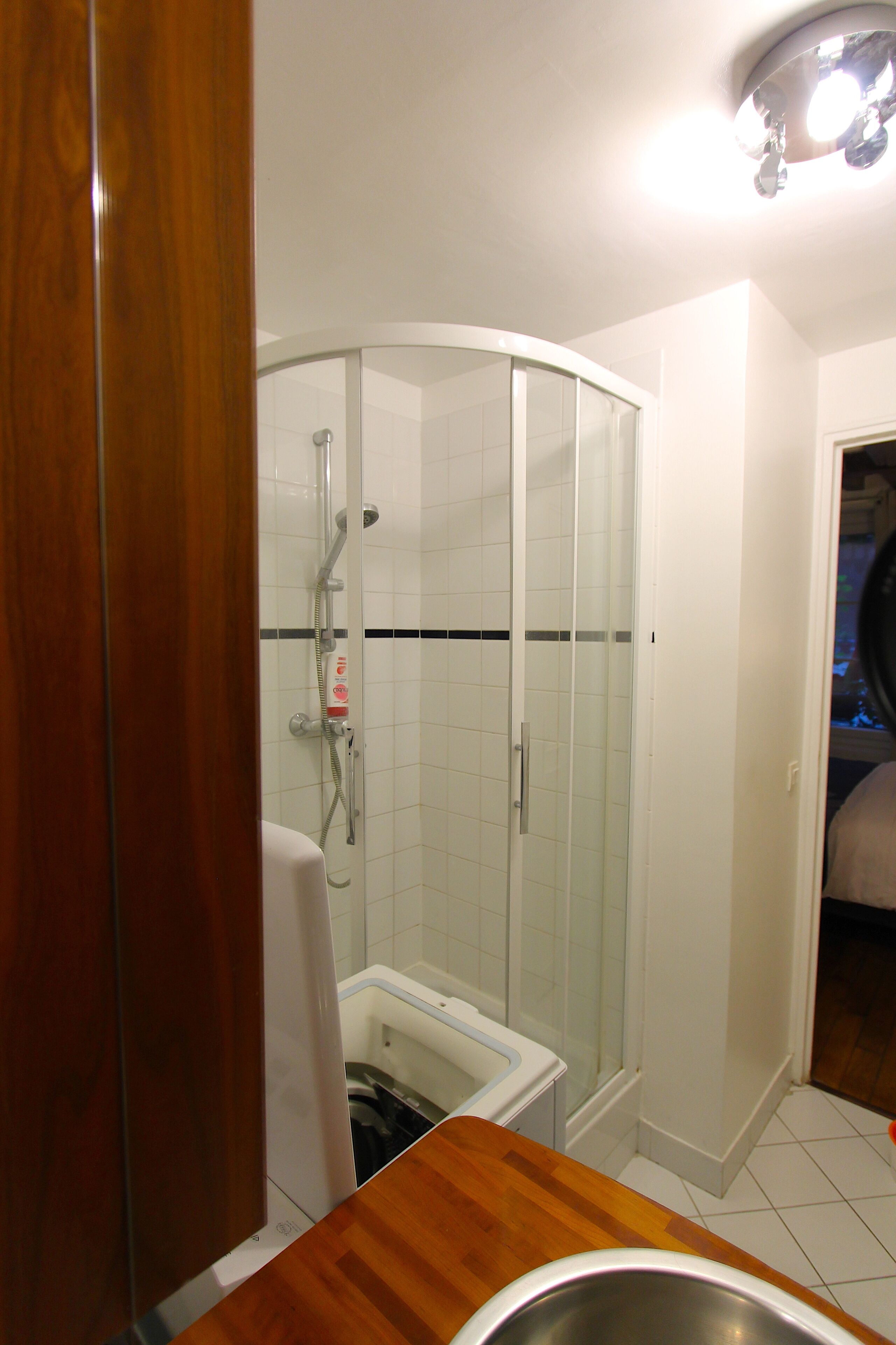A bathroom with a shower, a toilet, and a sink.