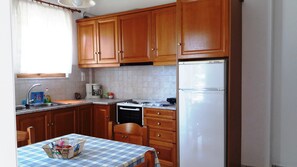 Enjoy cooking in this well-equipped kitchen with a coffee maker, sink, and dining table.
